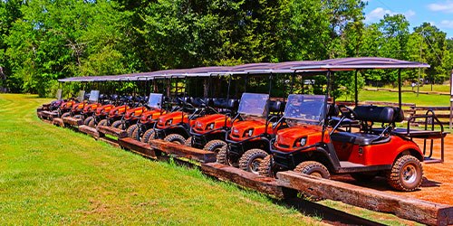 A row of golf carts parked at Able's Gun Club